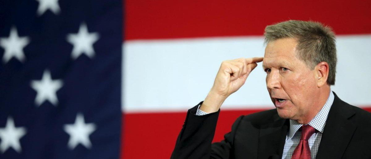 John Kasich points to head during speech