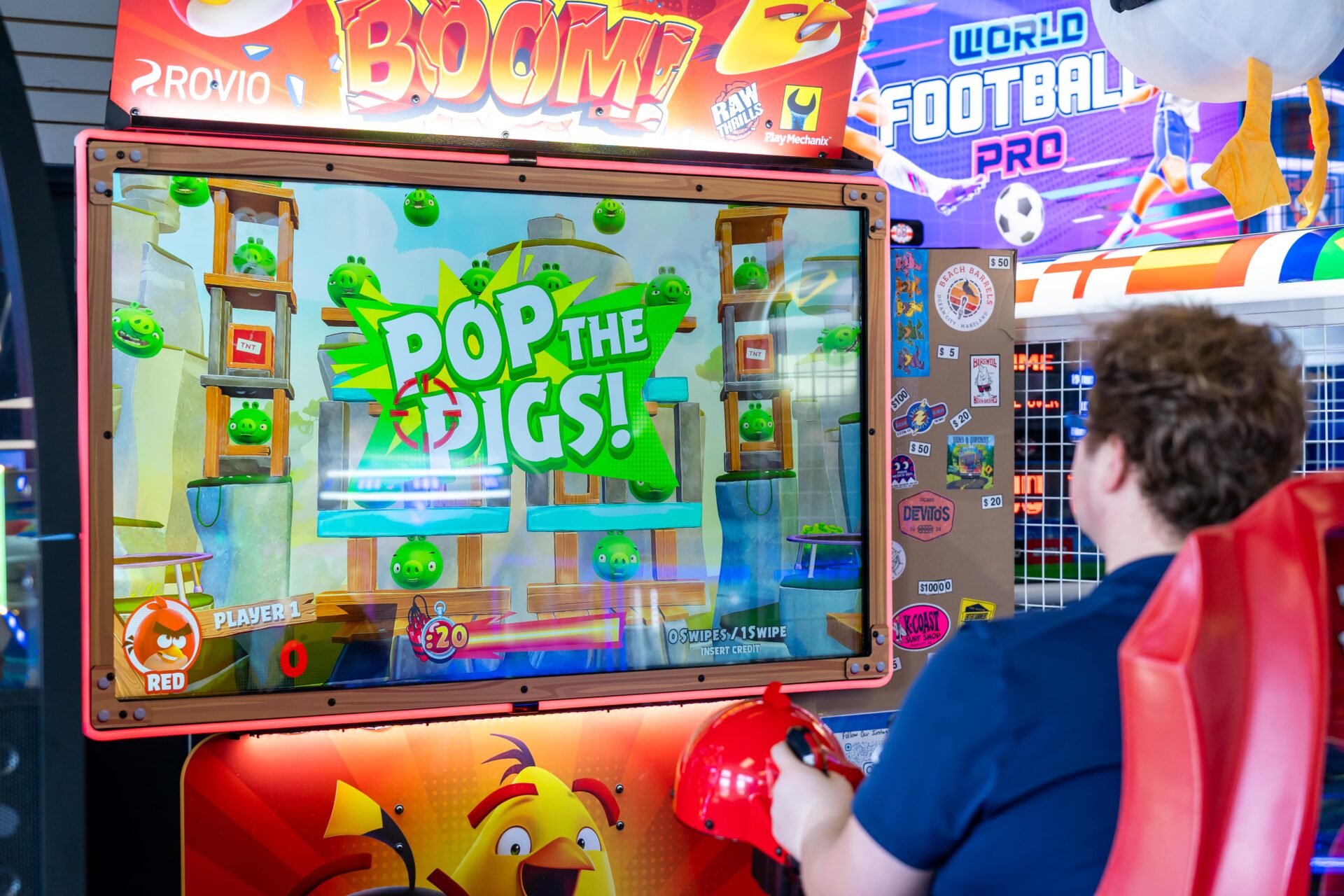 A person playing an Angry Birds game at an arcade.