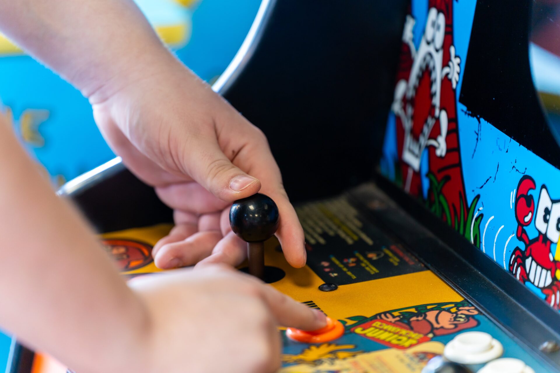 A person playing a game at an arcade.