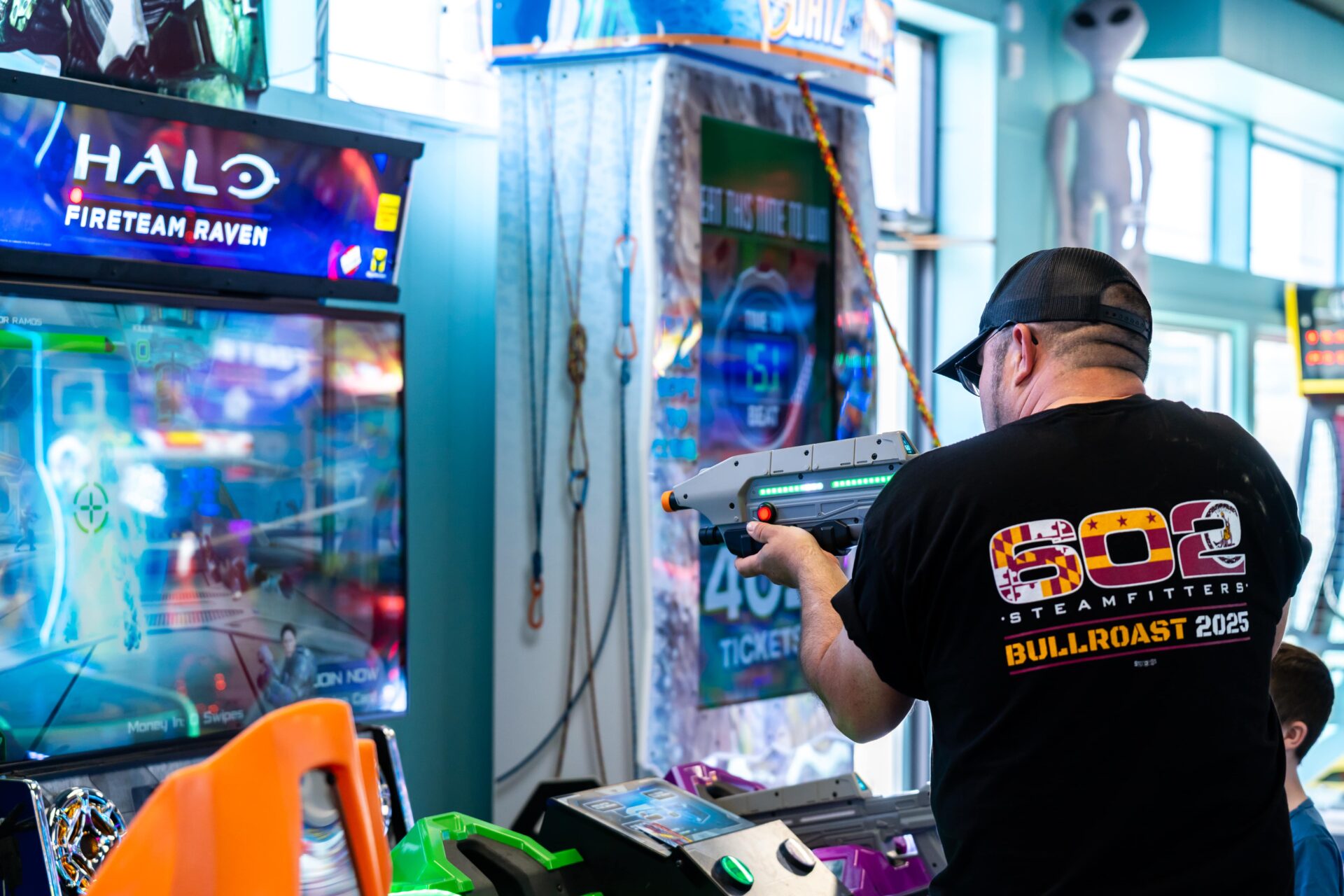A man playing a game at an arcade.