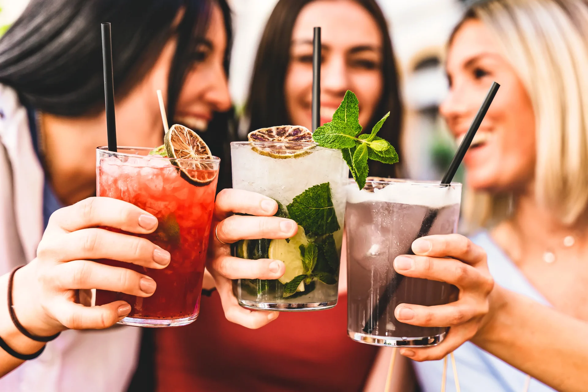 women holding drinks