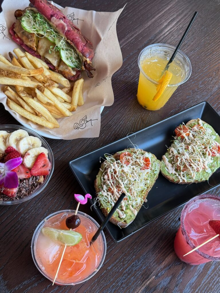 Avocado toast, acai bowl, sandwich meal, and colorful drinks