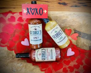 George's Beverage Company cocktail mixes bottles with red hearts around them