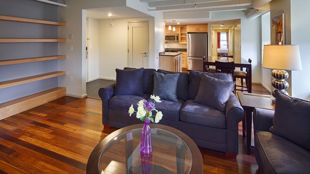 living area with dining area and kitchen in background