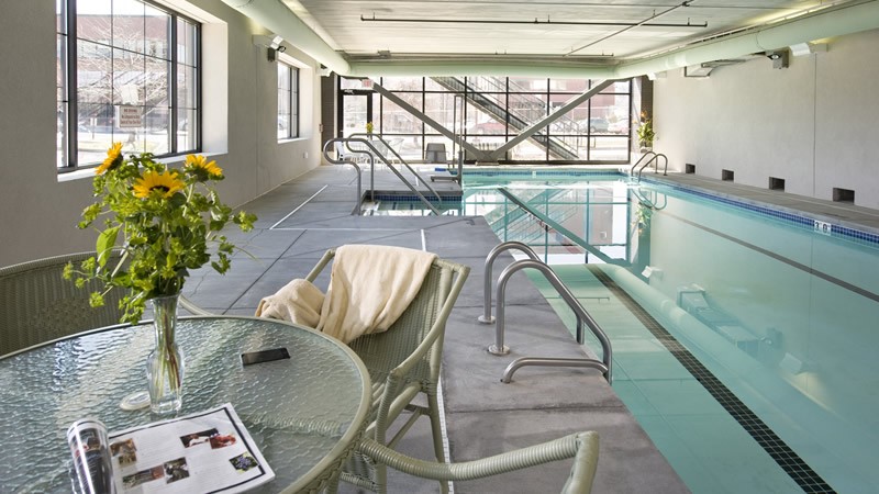 indoor pool with tables and lounge chairs