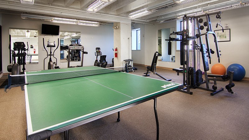 gym with ping pong table and exercise equipment