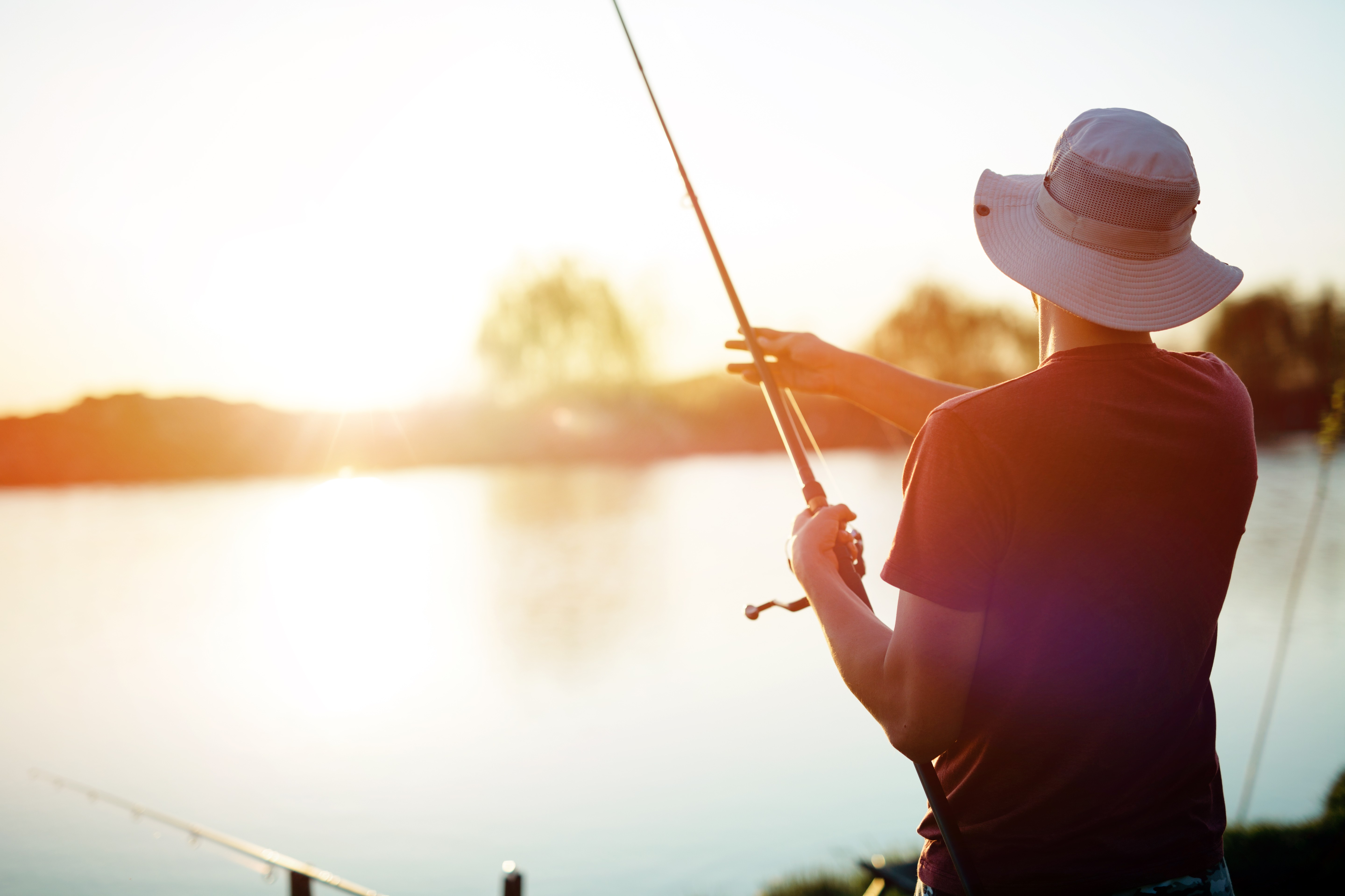 Young man fishing on a lake