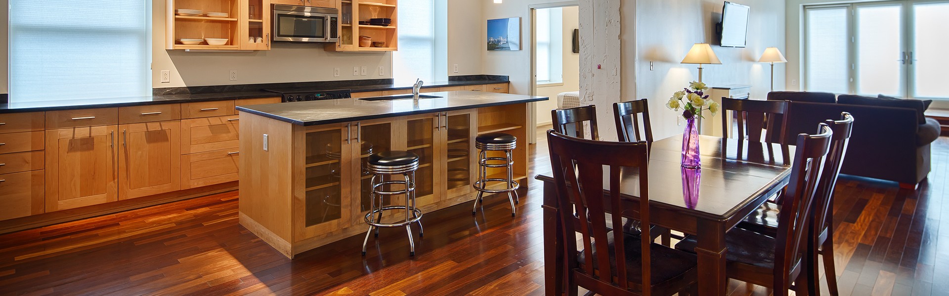 extended stay kitchen, dining area, and living room