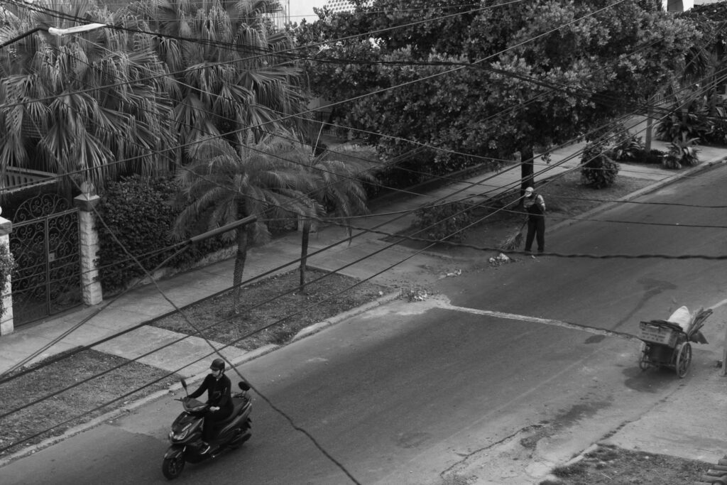 a man riding a motorcycle down the middle of a street