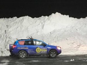 Happy Locks decal car in front of large snow bank
