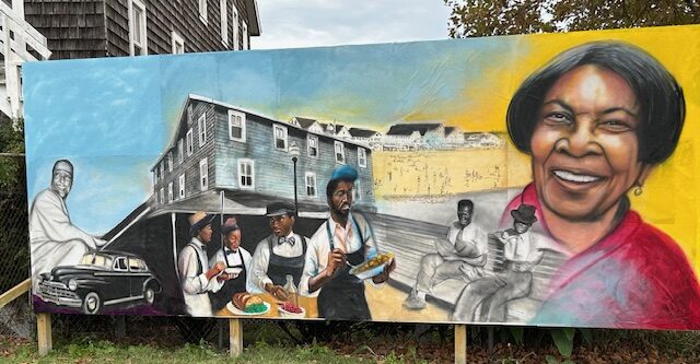 a large mural of a black woman on the side of a building