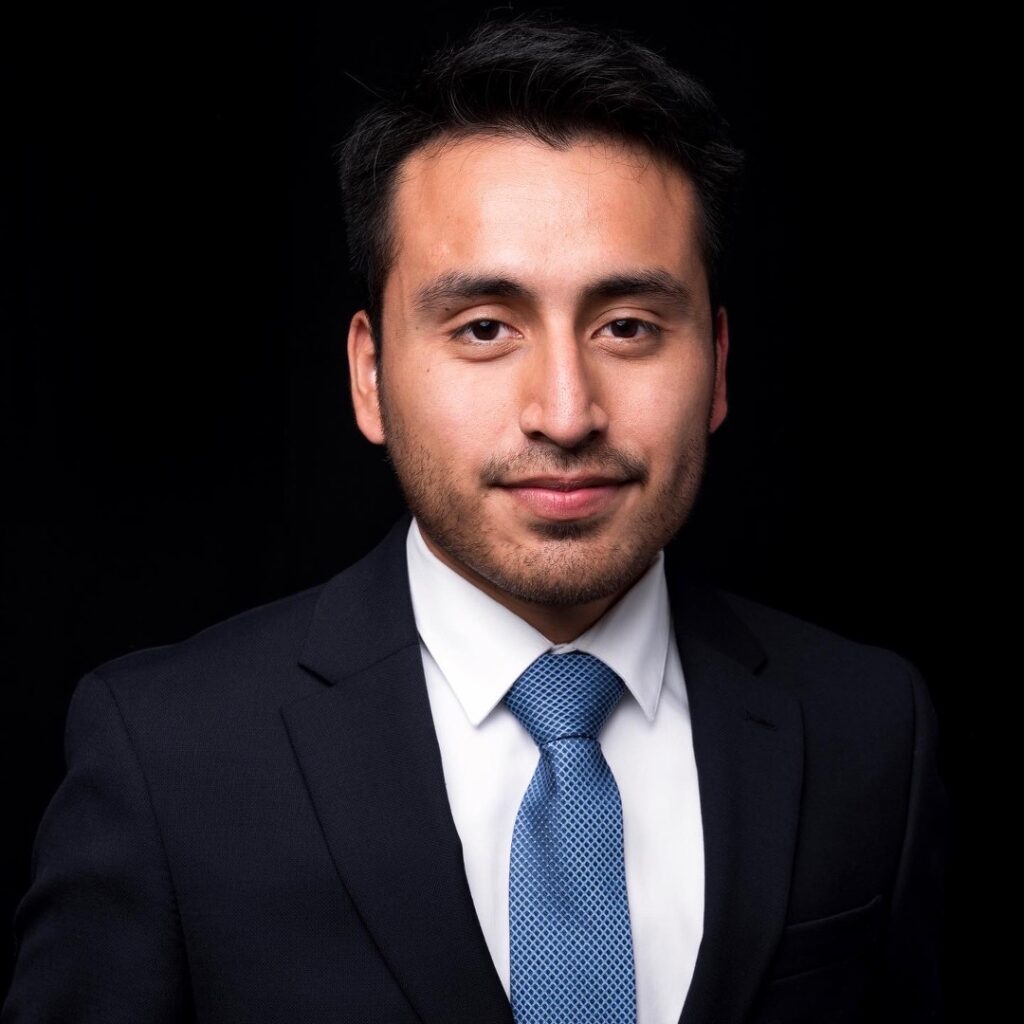 a man in a suit and tie posing for a photo
