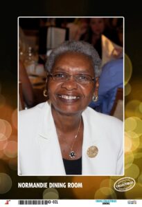 a woman with glasses and a white jacket