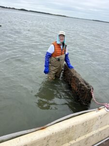 a man standing in the water next to a dock