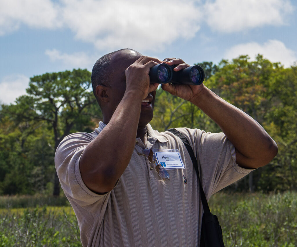 a man is looking through binoculars at the sky