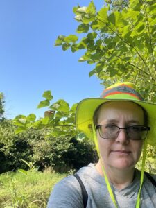 a woman wearing a green hat and glasses