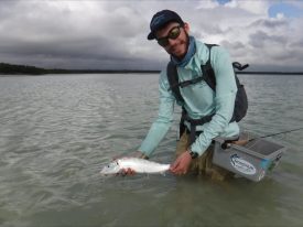 a man holding a fish in the water