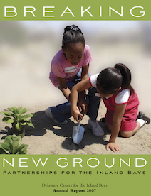 two young girls are playing in the sand