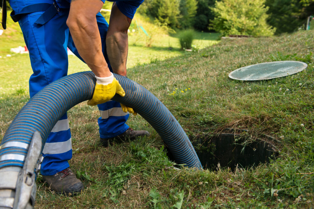 a man is using a vacuum to clean the grass