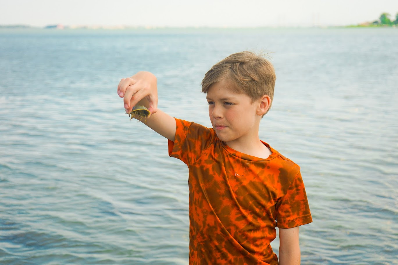 a young boy is holding something in his hand