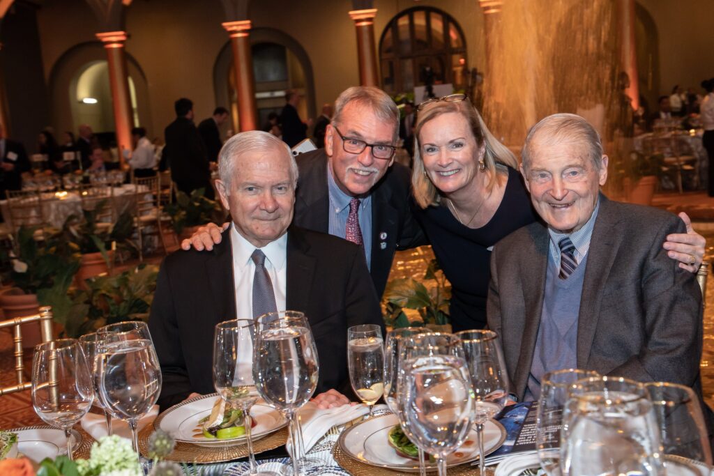 a group of people sitting at a table with wine glasses