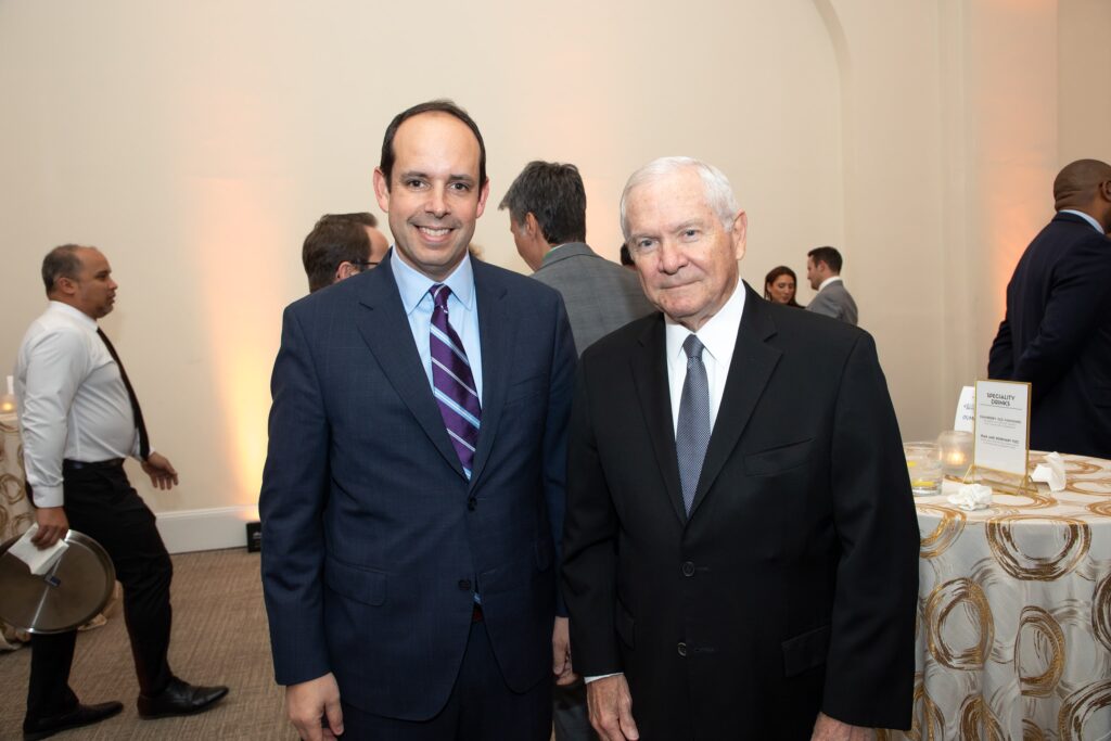 two men in suits standing next to each other
