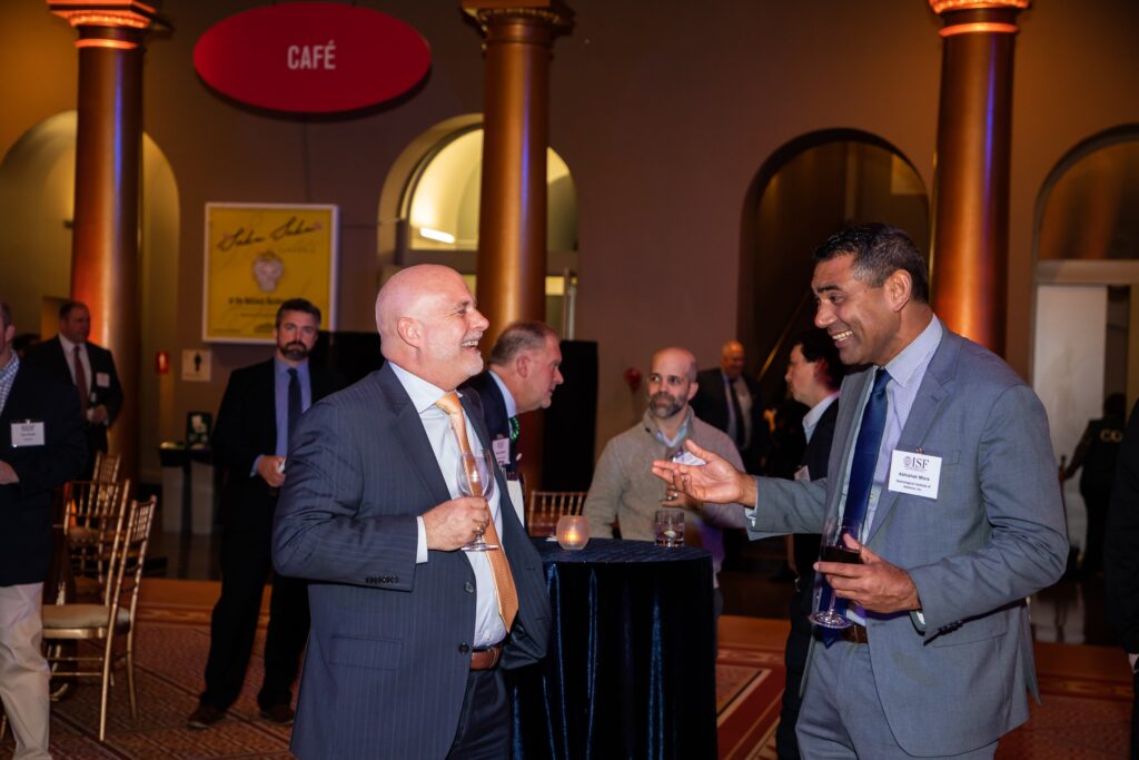 two men in suits talking to each other
