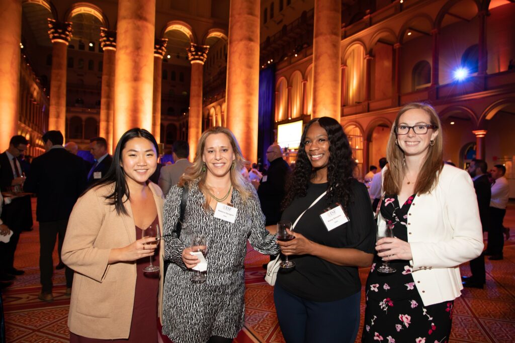 four women standing together at an event