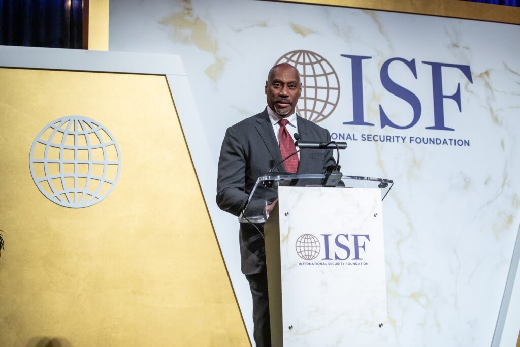 a man in a suit and tie standing at a podium