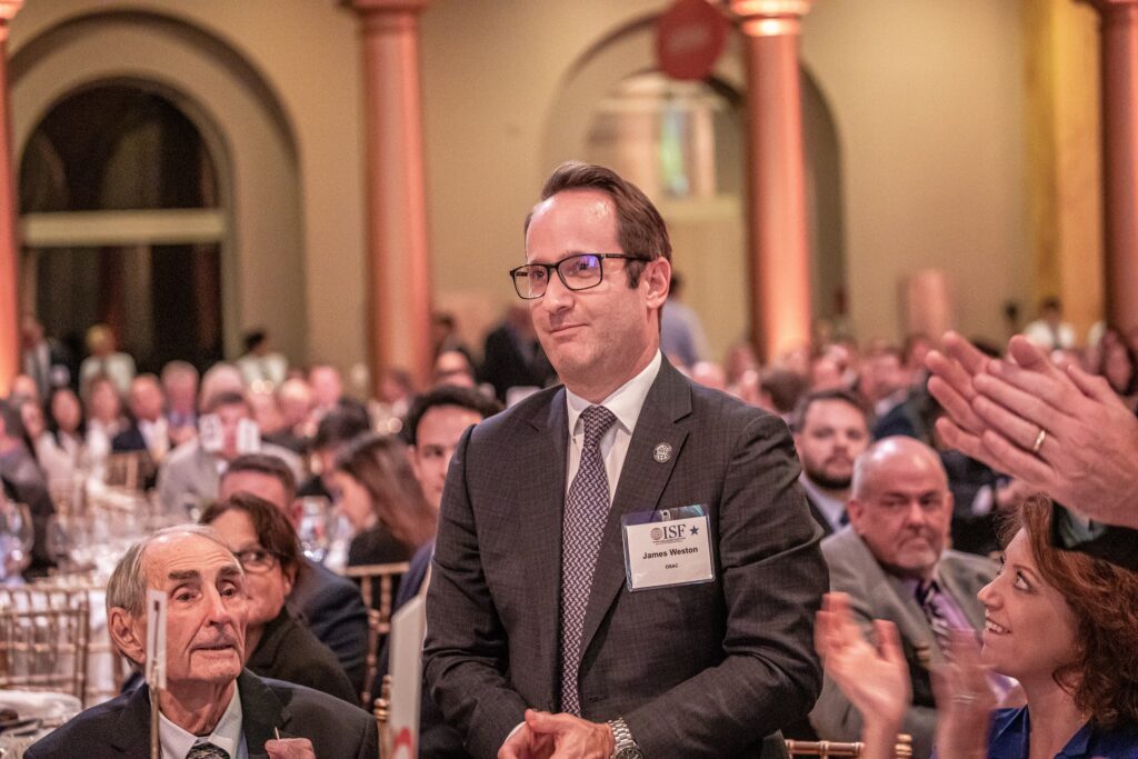 a man in a suit and tie sitting at a table