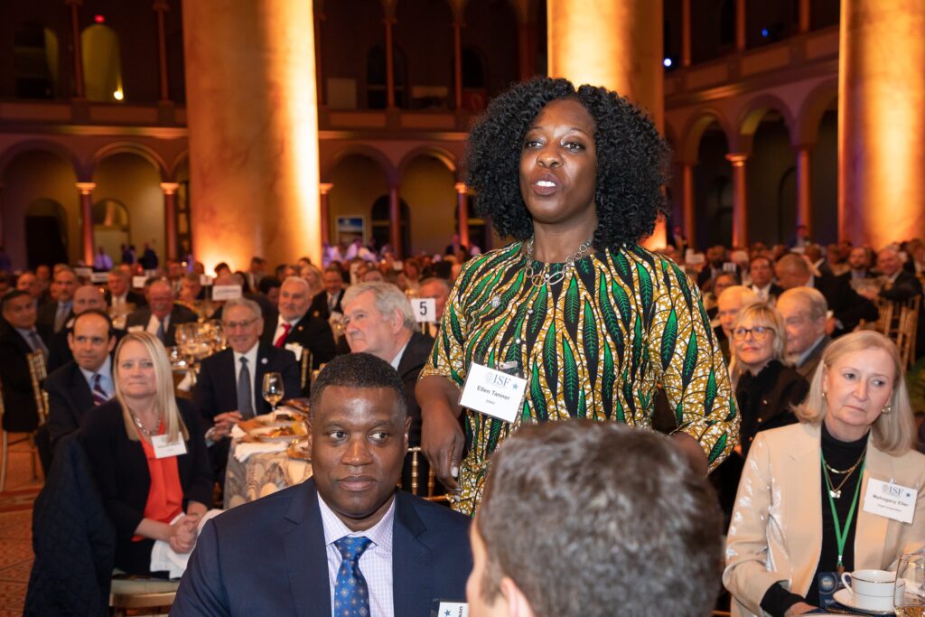 a woman standing in front of a crowd of people