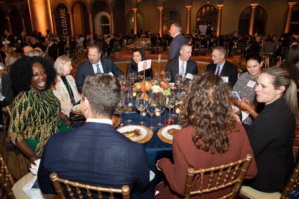 a group of people sitting around a dinner table