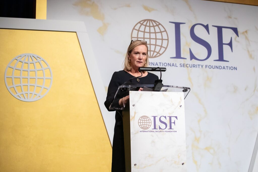 a woman standing at a podium giving a speech
