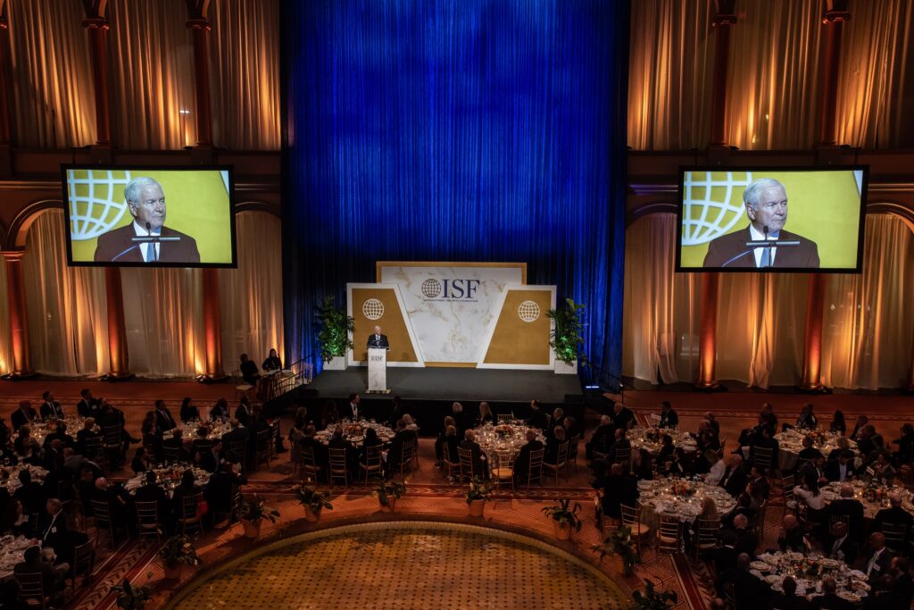 a large room filled with people sitting at tables