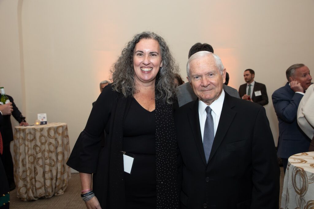 two people standing next to each other in a room