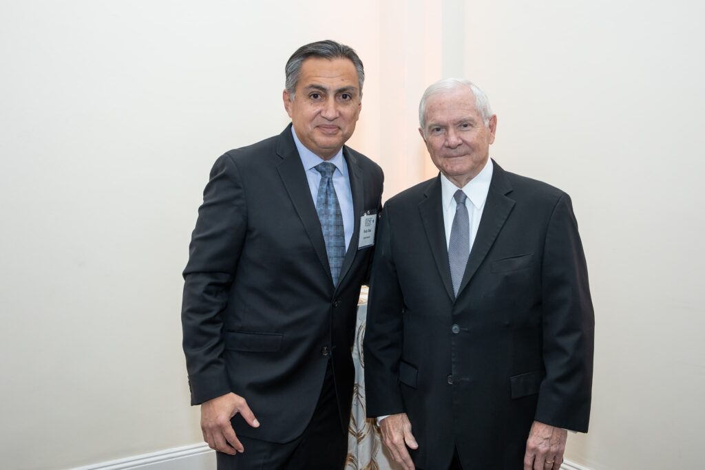 two men in suits standing next to each other