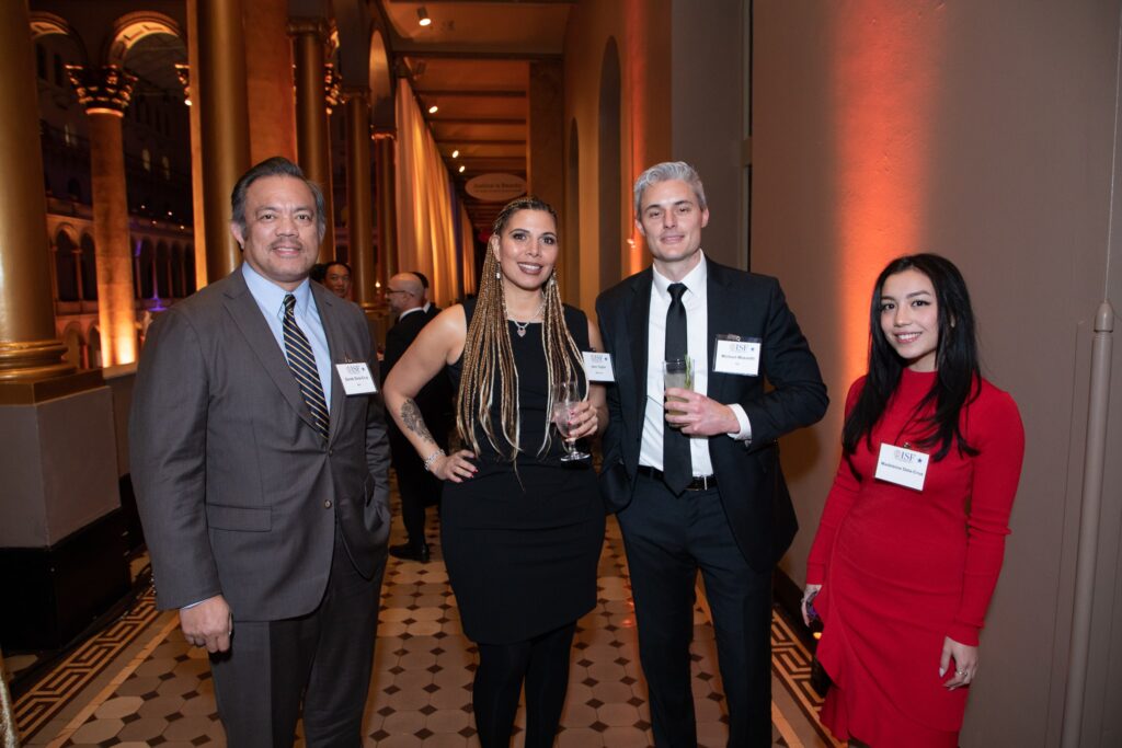 three people standing next to each other at an event