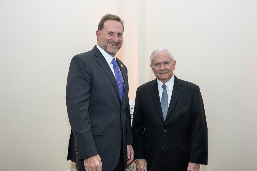 two men in suits standing next to each other