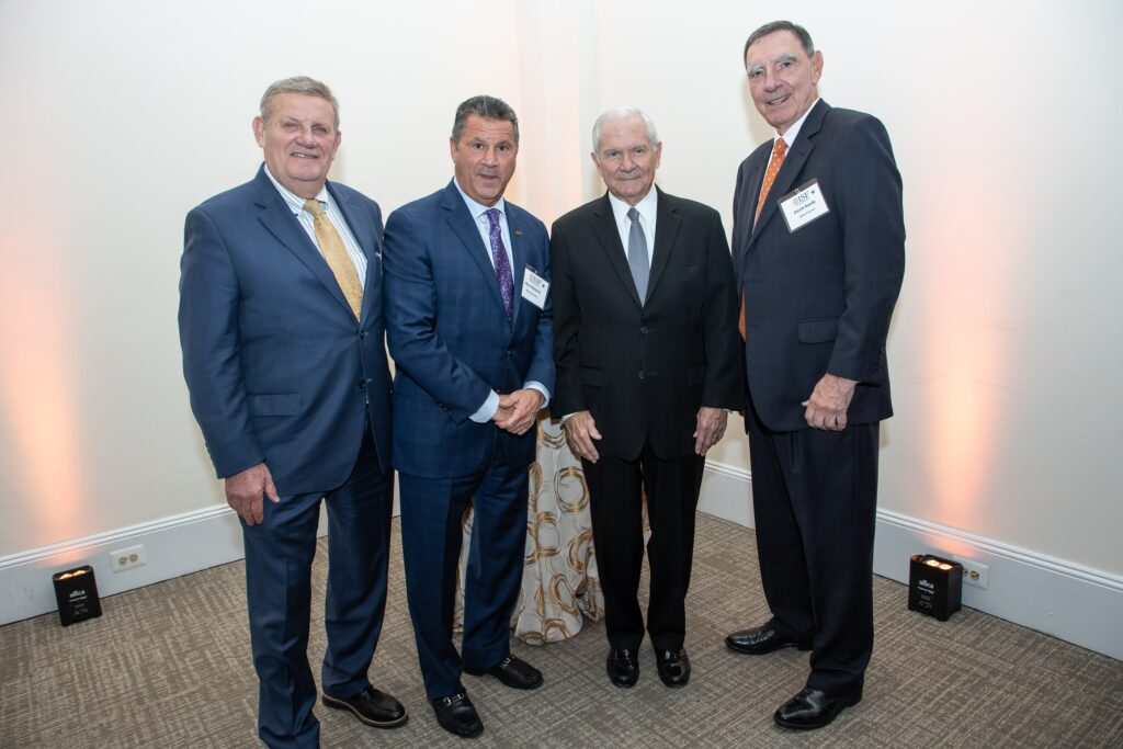 three men in suits and ties standing next to each other