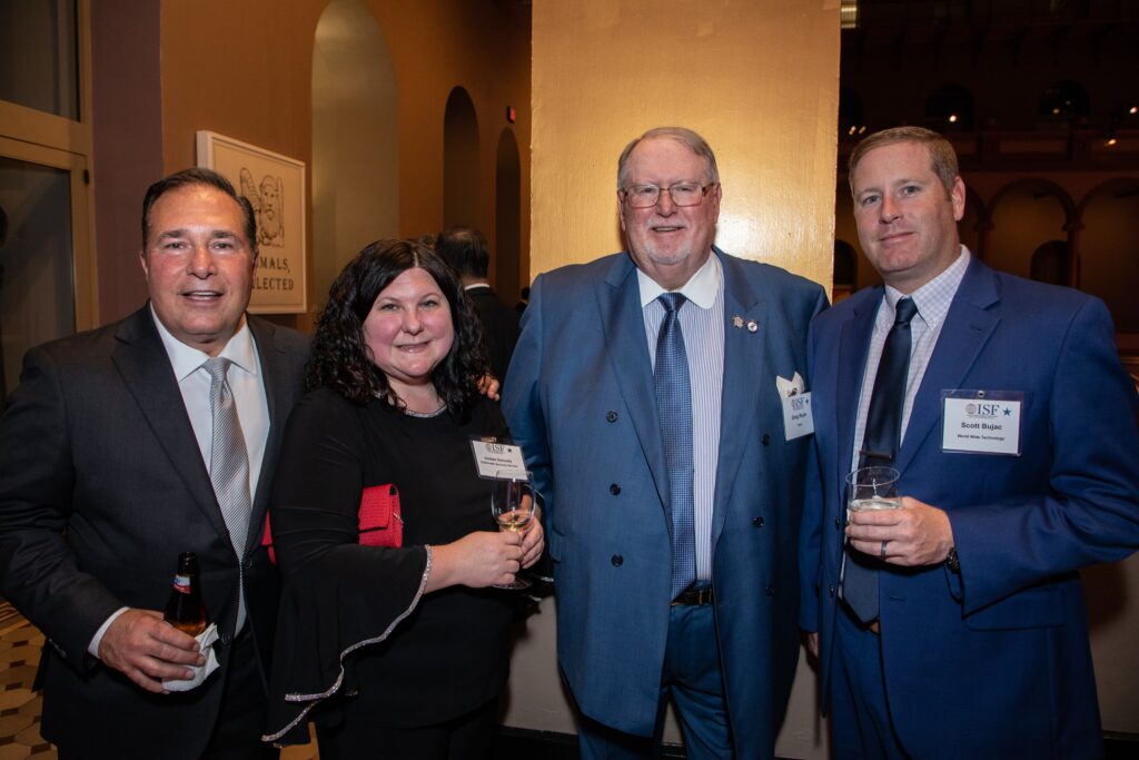three men and a woman posing for a photo