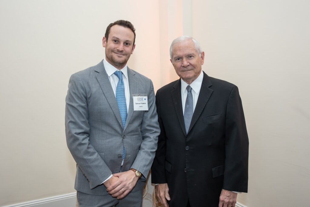 two men in suits standing next to each other