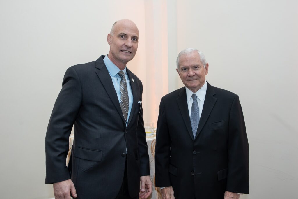 two men in suits standing next to each other