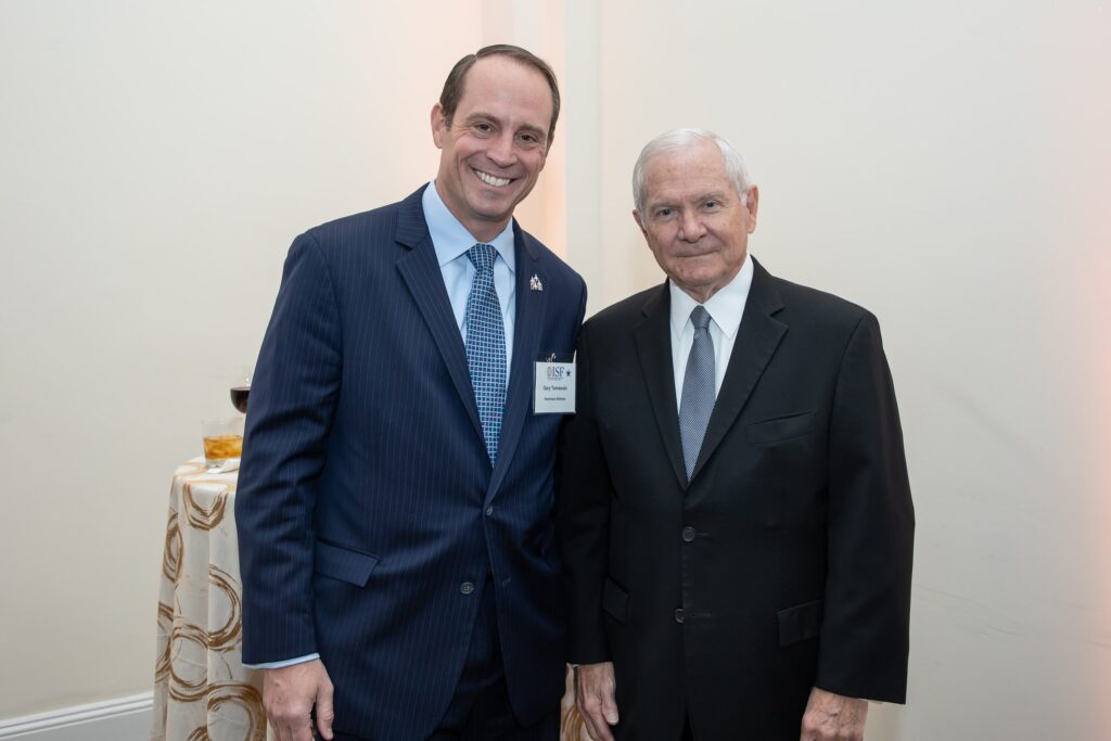 two men in suits standing next to each other