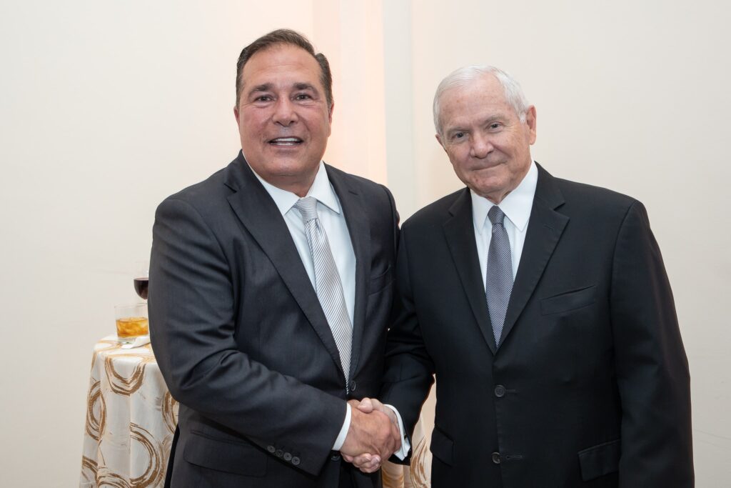 two men in suits are shaking hands