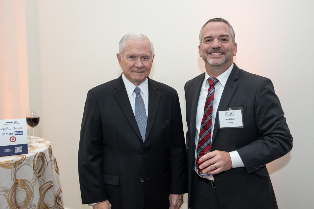 two men standing next to each other near a table