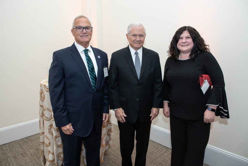 two men and a woman standing next to each other
