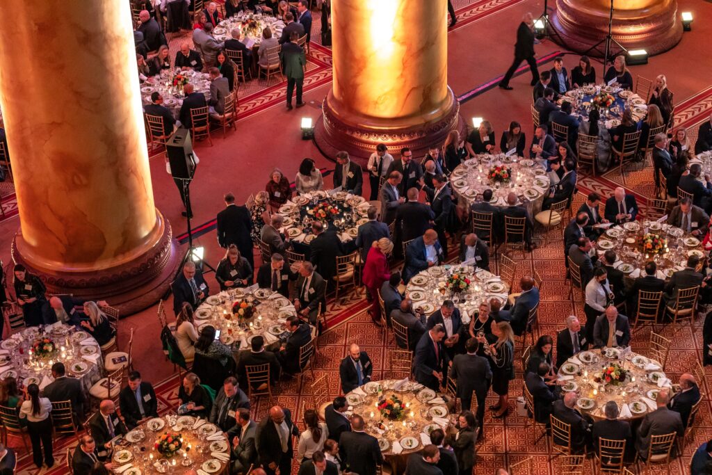 a large group of people sitting around tables