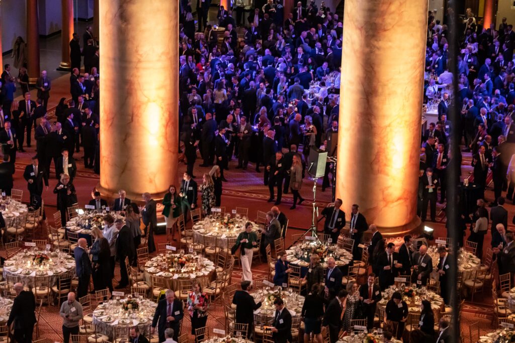 a large group of people standing around tables