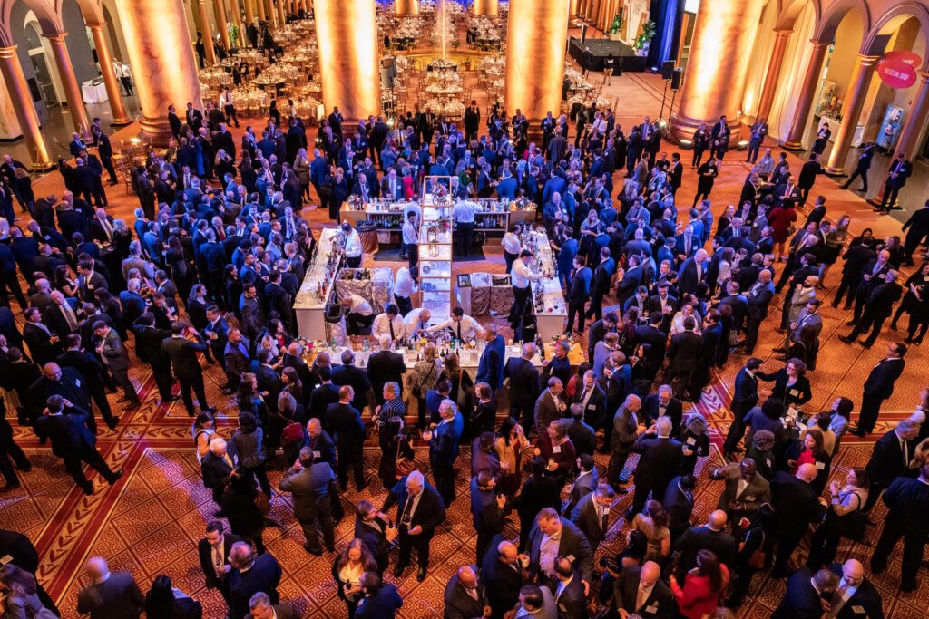 a large group of people standing in a room