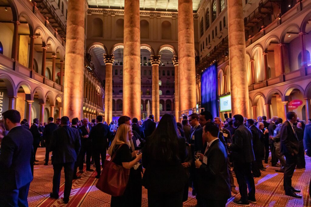 a group of people standing in a large building